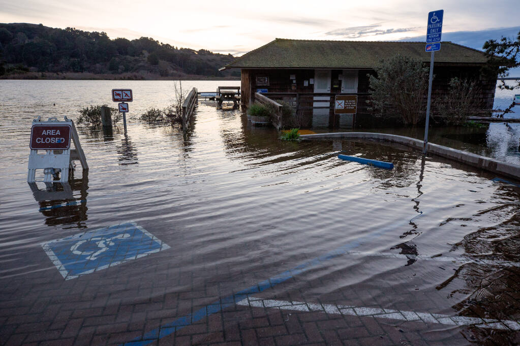 Water from the Russian River begins to innundate the Jenner visitor center and its parking lot in Jenner, California, on Thursday, Jan. 7, 2021. (Alvin A.H. Jornada / The Press Democrat)