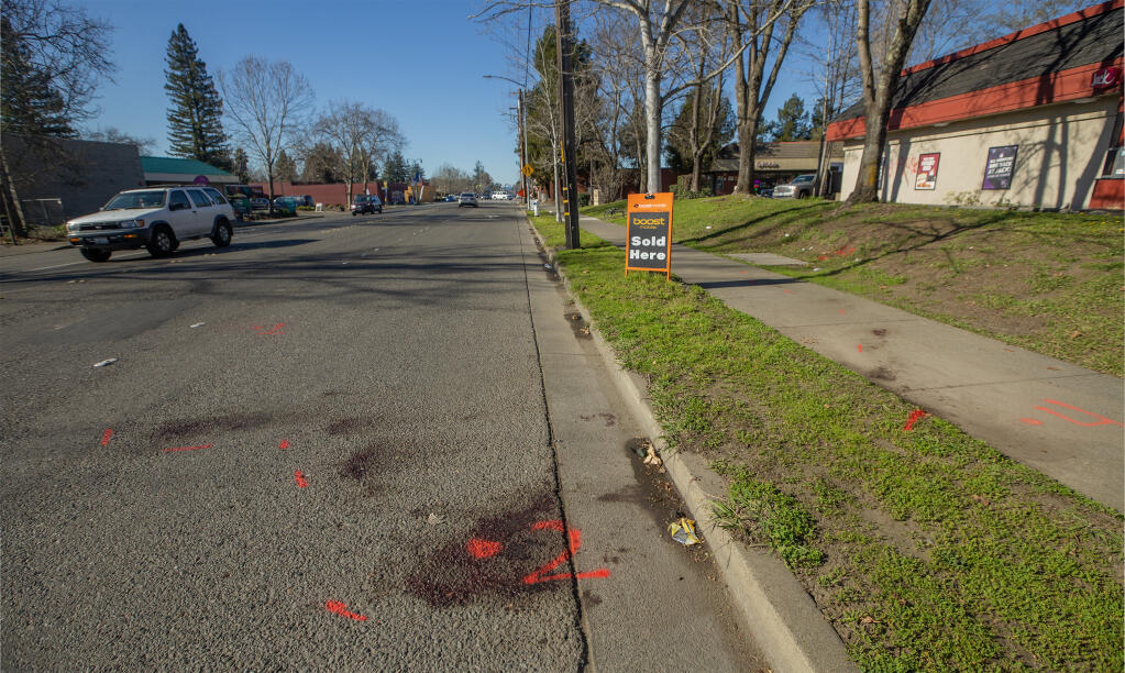 Orange investigation markings in the westbound shoulder of Sebastopol Road at Dutton Avenue in Santa Rosa where a man was killed in a stabbing, Wednesday, Jan. 25, 2023. Photo taken Thursday, Jan. 26, 2023. (Chad Surmick/The Press Democrat)