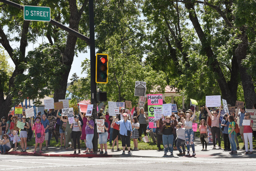 A large group of protesters gathered at Walnut Park as part of a nationwide “Bans Off Our Bodies” rally in response to the leaked Supreme Court draft opinion to overturn Roe. v. Wade, held in Petaluma on Saturday, May 14, 2022. (Erik Castro/for The Press Democrat)