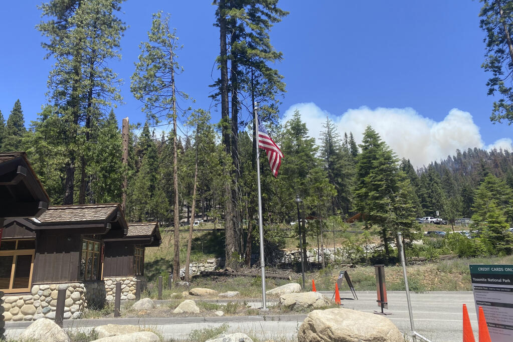 In this photo provided by the National Park Service, smoke rises from the Washburn Fire near the south entrance to Yosemite National Park, Calif., Wednesday, July 13, 2022. A wildfire that threatened a grove of California's giant sequoias in Yosemite National Park is burning eastward into the Sierra National Forest. The Washburn Fire grew to 5.8 square miles, decreasing containment Wednesday from 22% to 17%. (National Park Service via AP)