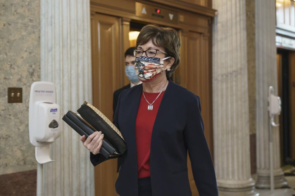 Sen. Susan Collins, R-Maine, arrives for votes during a rare weekend session to advance the confirmation of Judge Amy Coney Barrett to the Supreme Court, at the Capitol in Washington, Sunday, Oct. 25, 2020. (AP Photo/J. Scott Applewhite)