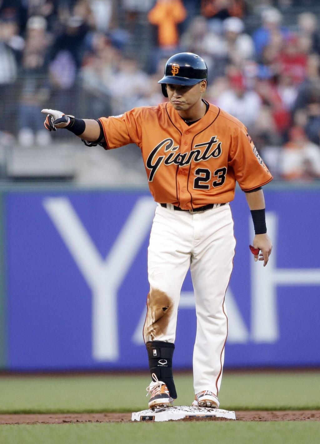 San Francisco Giants' Nori Aoki points to the dugout after hitting a double against the Los Angeles Angels during the first inning of a baseball game on Friday, May 1, 2015, in San Francisco. (AP Photo/Marcio Jose Sanchez)