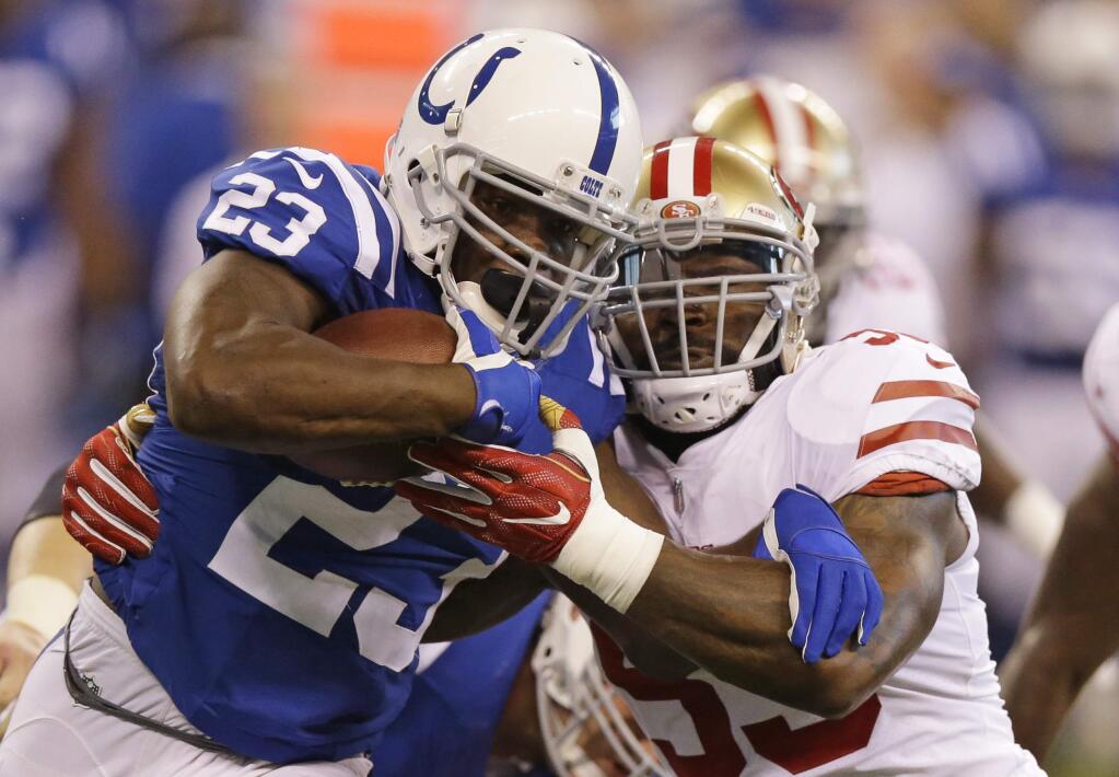 The Indianapolis Colts' Frank Gore, left, is tackled by the San Francisco 49ers' NaVorro Bowman during the first half Sunday, Oct. 8, 2017, in Indianapolis. (AP Photo/Michael Conroy)