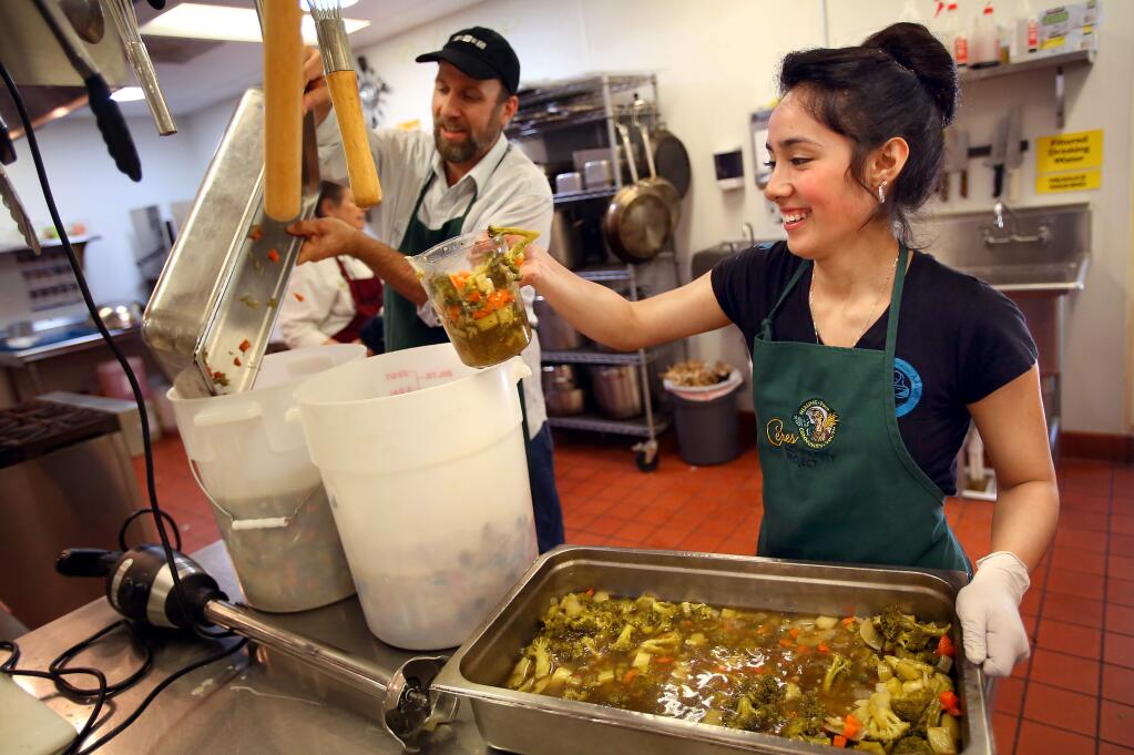 El Molino senior Zonia Lopez, right, helps prepare soup with executive chef Rob Hogencamp at the Ceres Community Project kitchen, in Sebastopol on Wednesday, April 1, 2015. Ceres is looking for volunteers for shifts at the SAY Dream Center in Santa Rosa. (Christopher Chung/ The Press Democrat)