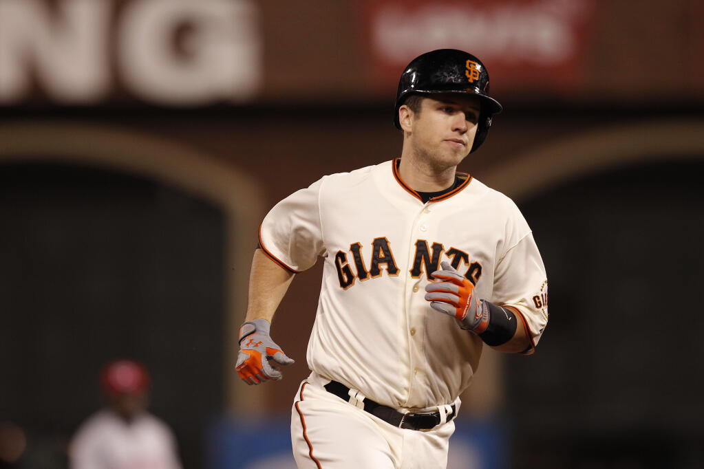 Giants catcher Buster Posey runs the bases after his solo home run in the sixth inning of Game 1 of the 2012 National League Division Series in San Francisco. (Michael Macor / San Francisco Chronicle)