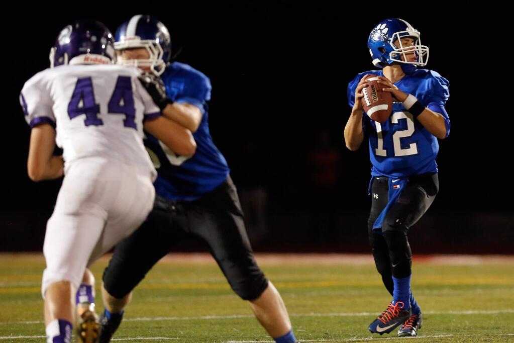 Analy quarterback Jack Newman (12) scans for an open receiver during the first half of the Sonoma County League championship football game between Petaluma and Analy high schools, in Rohnert Park, California on Friday, November 6, 2015. (Alvin Jornada / The Press Democrat)