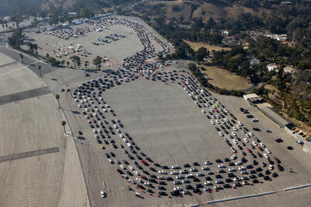 Motorists queue up to take a coronavirus test in a parking lot at Dodger Stadium, Monday, Jan. 4, 2021, in Los Angeles. (AP Photo/Ringo H.W. Chiu)