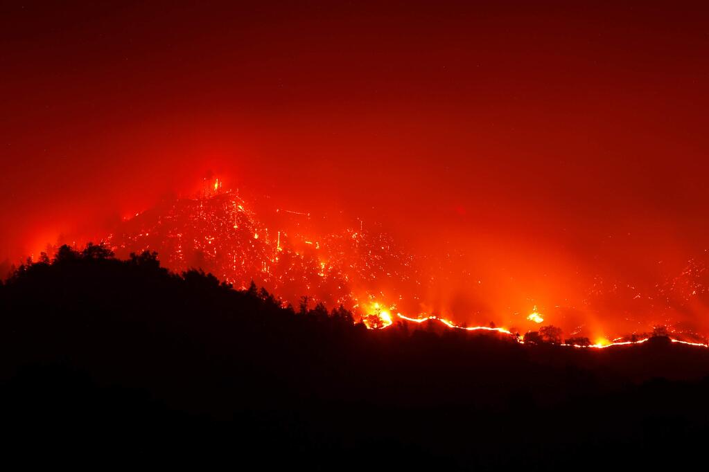 The Kincade Fire burns in the hills above Geyserville, California, on Friday, October 25, 2019. (Alvin Jornada / The Press Democrat)