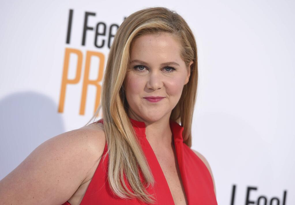 FILE - In this April 17, 2018 file photo, Amy Schumer arrives at the world premiere of 'I Feel Pretty' at the Westwood Village Theater in Los Angeles. Schumer announced she‚Äôs pregnant with husband Chris Fischer. She broke her baby news Monday on the Instagram stories of friend and journalist Jessica Yellin. (Photo by Jordan Strauss/Invision/AP, File)