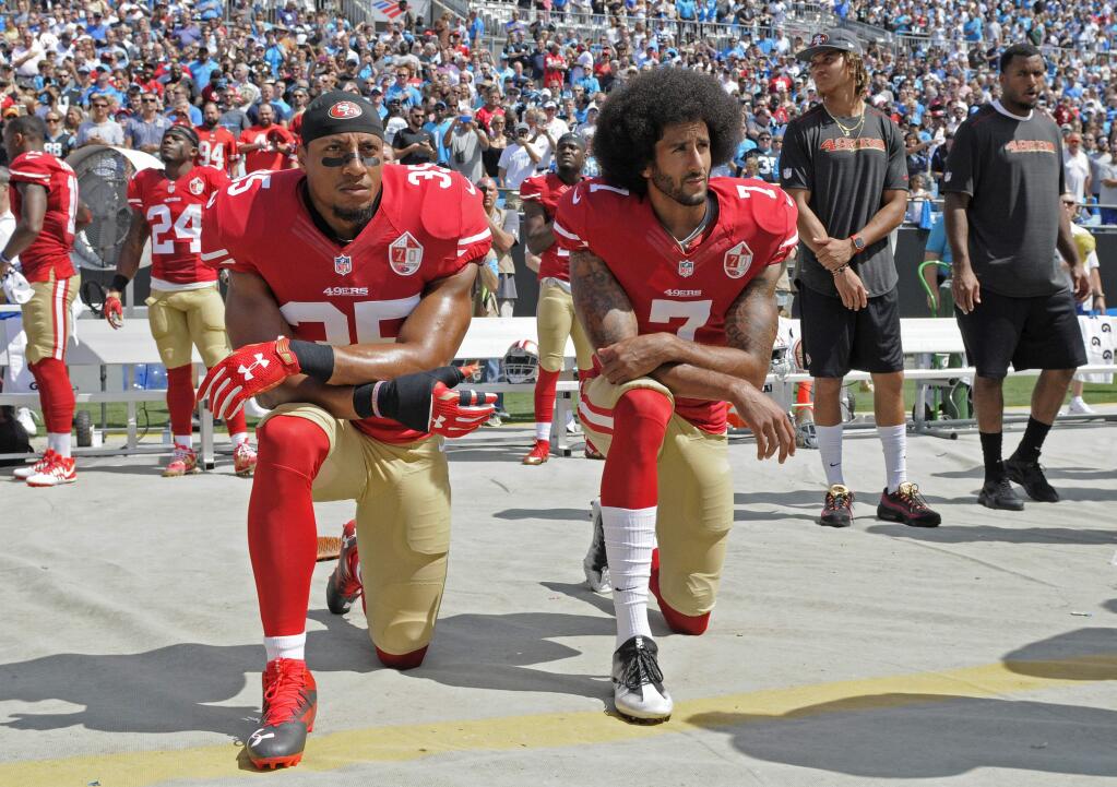 San Francisco 49ers' Colin Kaepernick (7) and Eric Reid (35) kneel during the national anthem before a game against the Carolina Panthers in Charlotte, N.C., Sunday, Sept. 18, 2016. (AP Photo/Mike McCarn)