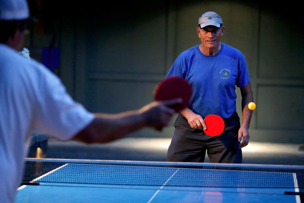 Jim Ouimette, right, receives a volley from Jeff Tyler during the weekly ping-pong tournament at Palooza Gastropub in Kenwood, California, on Tuesday, September 12, 2017. (ALVIN JORNADA / PD)