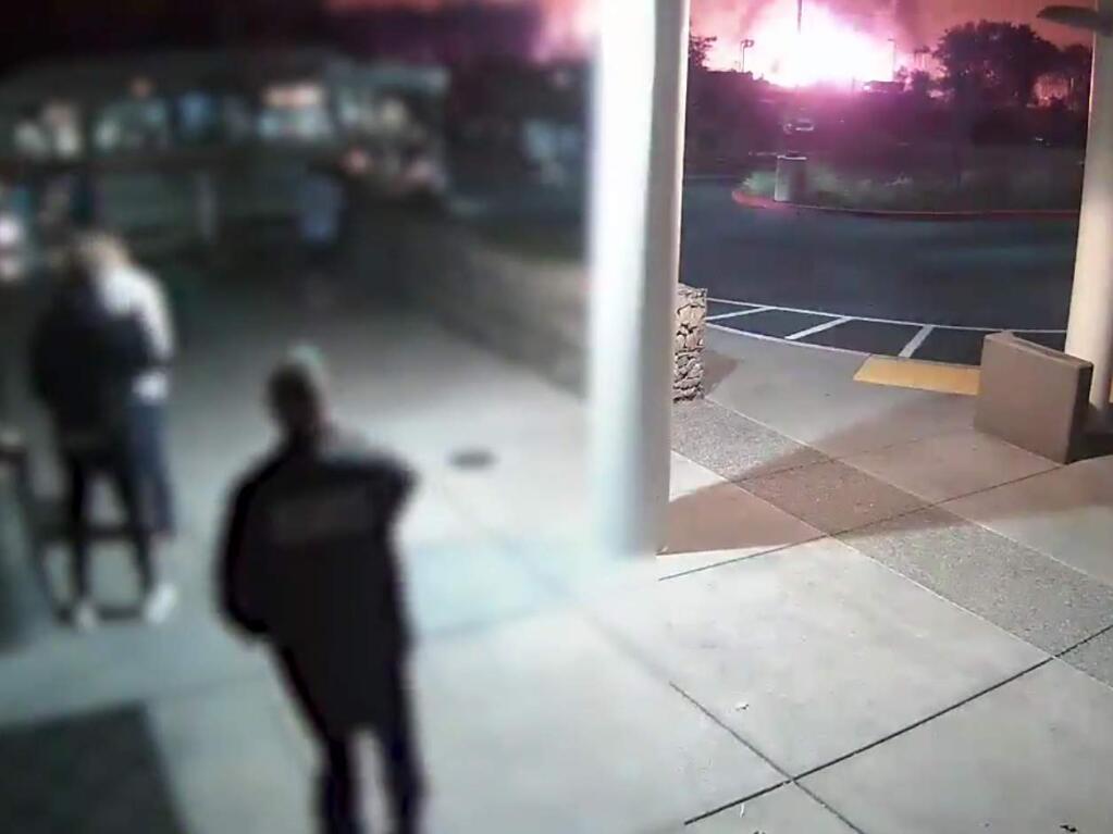 With flames in the background, security cameras captured the moment Sutter Hospital evacuated its patients and workers on Oct. 9. (Sutter Santa Rosa Regional Hospital)