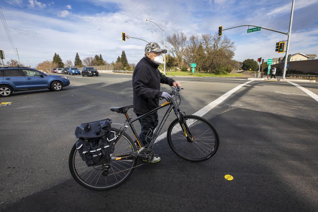 Wayne Morris, 82, now gets off his bike to walk it across Stony Point Road in Santa Rosa after he was hit by a car in the intersection about five weeks ago on his daily ride from his home in Sebastopol along the Joe Rodota trail. Santa Rosa is looking into changes to keep pedestrians and bicyclists safe at both the north and south sides of Highway 12. Photo taken on Thursday, Jan. 21, 2021. (John Burgess / The Press Democrat)