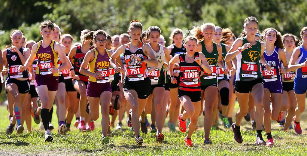 Winner Morgin Coonfield of McKinleyville, #1066. and second place finisher Delaney White of Santa Rosa, #751 lead the crowded field of senior girls at the Viking Opener at Spring Lake in Santa Rosa on Saturday. (JOHN BURGESS / The Press Democrat)