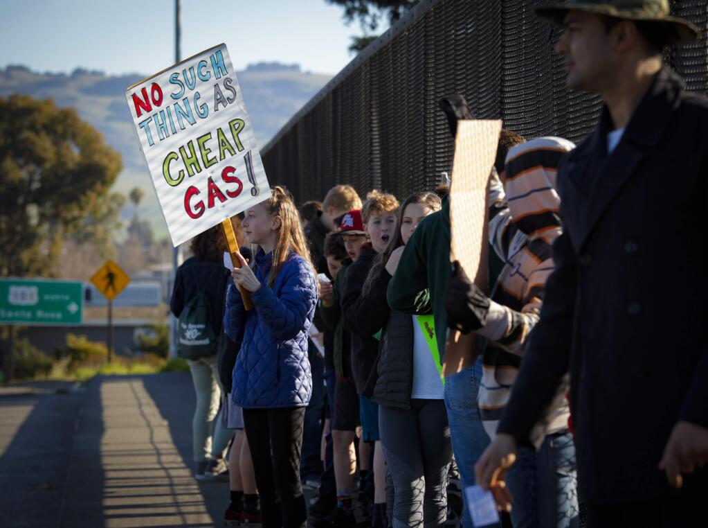 Petaluma, CA, USA._Friday, March 15, 2019. Students from Petaluma schools participated in a rally and protest over climate change and the current administration's environmental policies. The 'climate strikers' walked out of school and marched on East Washington to the freeway overpass to bring attention to their cause.(CRISSY PASCUAL/ARGUS-COURIER STAFF)