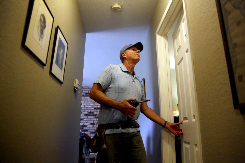 Steve Lightman of Door Replacements of Sonoma County installs a new door at a home in Sebastopol, on Wednesday, April 27, 2016. (BETH SCHLANKER/ The Press Democrat)