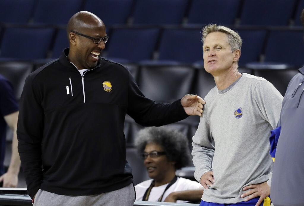 Golden State Warriors head coach Steve Kerr, right, talks with interim head coach Mike Brown during an NBA basketball practice, Wednesday, May 31, 2017, in Oakland, Calif. The Golden State Warriors face the Cleveland Cavaliers in Game 1 of the NBA Finals on Thursday in Oakland. (AP Photo/Marcio Jose Sanchez)