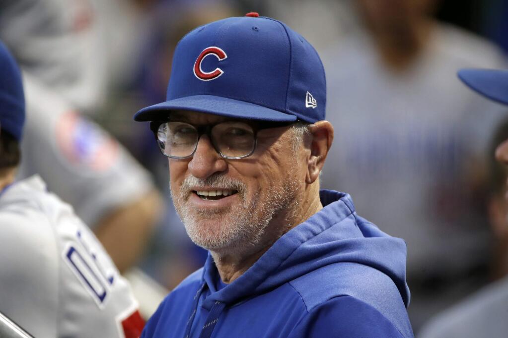 FILE - In this Sept. 25, 2019, file photo, then-Chicago Cubs manager Joe Maddon stands in the dugout before a baseball game against the Pittsburgh Pirates, in Pittsburgh. Joe Maddon has agreed to become the Los Angeles Angels' manager. Maddon and the Angels agreed to terms Wednesday, Oct. 16, 2019, on a deal to reunite the veteran manager with the organization where he spent the first three decades of his baseball career. (AP Photo/Gene J. Puskar, File)