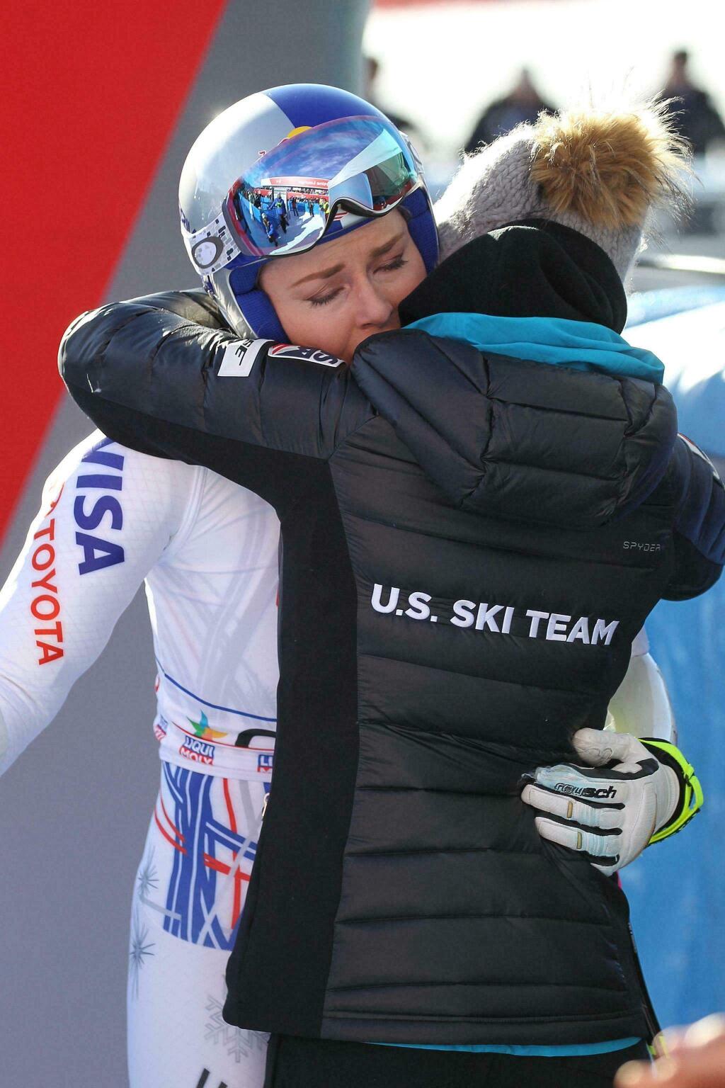 In this Sunday, Jan. 20, 2019 file photo, the United States' Lindsey Vonn hugs a U.S. team staffer in the finish area of the women's World Cup super-G race in Cortina D'Ampezzo, Italy. (Andrea Solero/ANSA via AP)