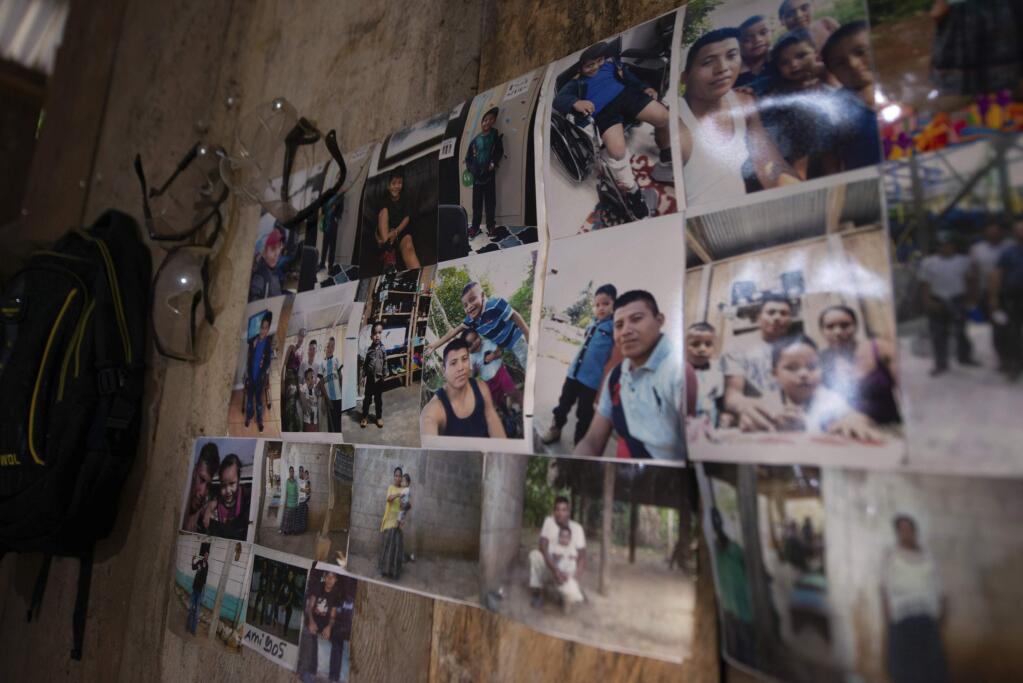 Family photos of David Xol hang on a wall in his one-bedroom home in San Miguel El Limon, 475 kilometers (295 miles) away from Guatemala City, Sunday, June, 23, 2019. Fourteen months earlier, his son, Byron, was packed in a wooden crate by smugglers and shipped from Guatemala to the U.S., only to be grabbed immediately by border agents and ripped away from him. (AP Photo/Santiago Billy)