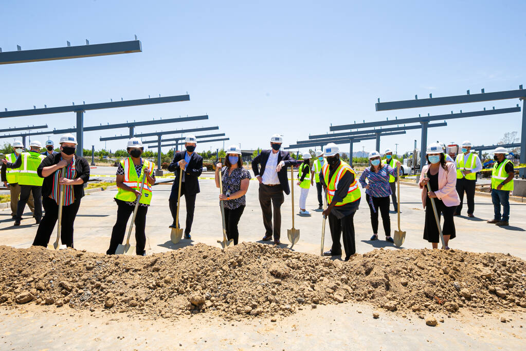 Representatives of State Compensation Insurance Fund participate in the groundbreaking ceremony May 12, 2021, at the Vacaville office complex for the installation of a 5.4-megawatt photovoltaic and 2 megawatt-hour battery energy system with 30 electric vehicle chargers and infrastructure for 70 more. Pictured with shovels are, from left, Heather Entzel, Adrianne Pitts, Vern Steiner, Debbi Gable, Andreas Acker, Marc Burrell, Eileen Gallagher and Teresa Navarec. (courtesy of State Compensation Insurance Fund)