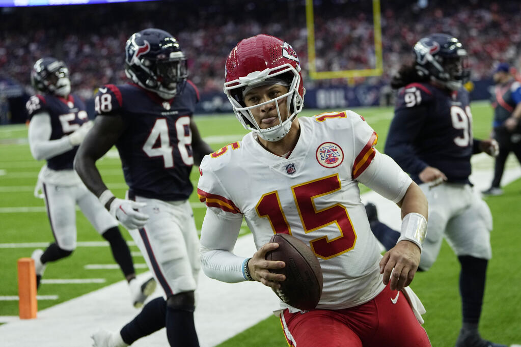 Chiefs quarterback Patrick Mahomes scores on a run against the Texans during the second half Sunday in Houston. (AP Photo/David J. Phillip)