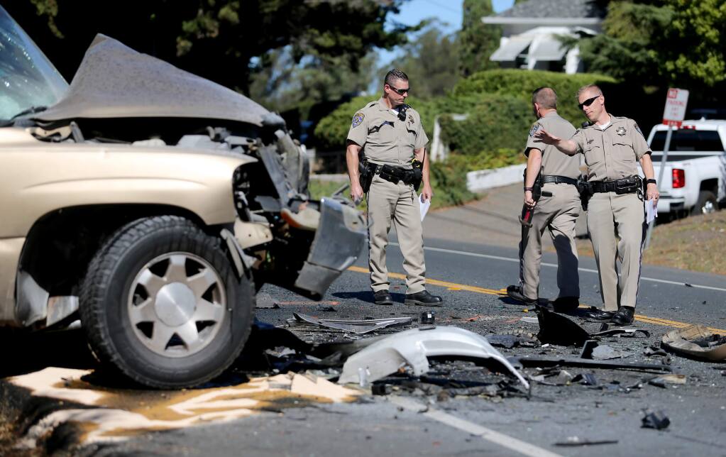 CHP officers investigate the scene of a double fatality on Bodega Avenue on Sunday, Oct. 7, 2018, in Petaluma, California. (BETH SCHLANKER/ PD)