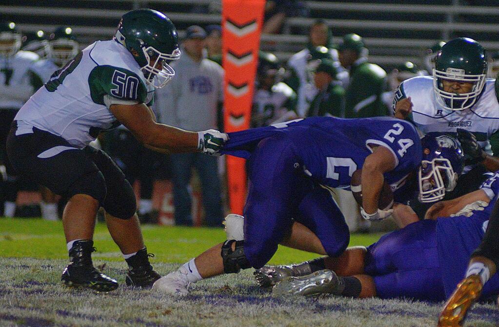 SUMNER FOWLER/FOR THE ARGUS-COURIERNot even a shirt-tail tackle by Rodriguez's Vinnie Quichocho could prevent Petaluma's Conner Richardson from scoring one of his three touchdowns.