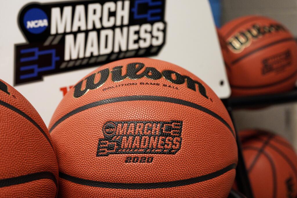 Official March Madness 2020 tournament basketballs are seen in a store room at the CHI Health Center Arena, in Omaha, Neb., Monday, March 16, 2020. Omaha was to host a first and second round in the NCAA college basketball Division I tournament, which was cancelled due to the coronavirus pandemic. (AP Photo/Nati Harnik)
