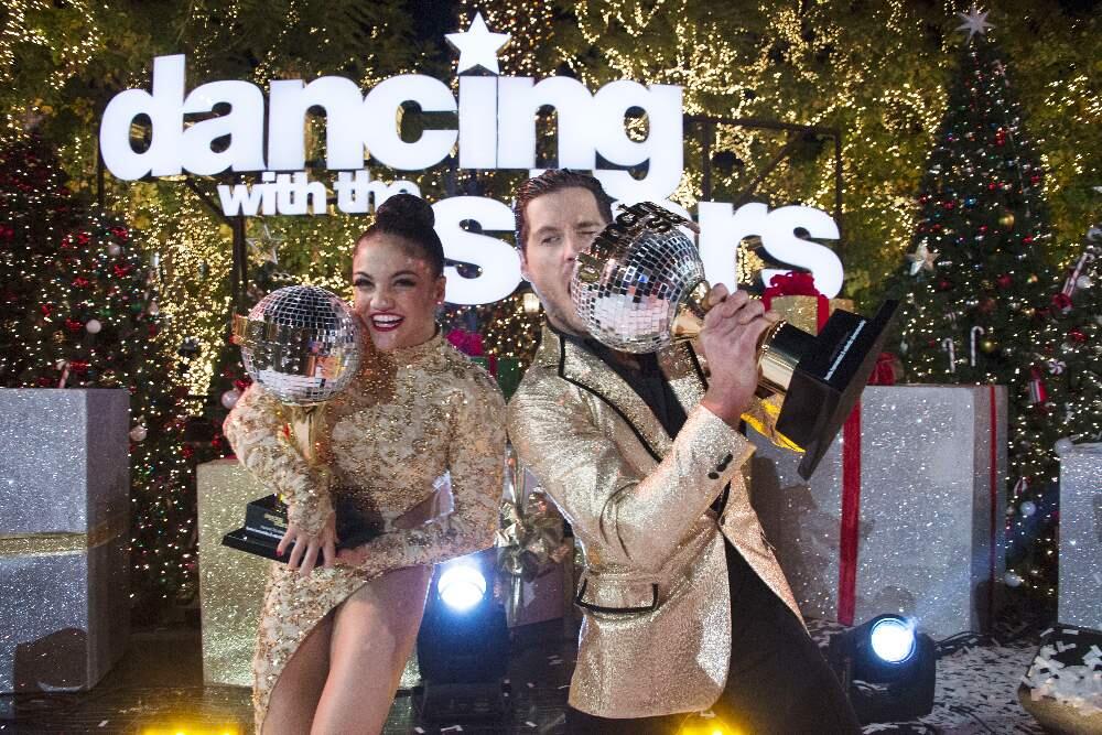 In this Nov. 22, 2016 photo released by ABC, Laurie Hernandez, left, and Val Chmerkovskiy celebrate after winning the 23rd season of the celebrity dance competition series, 'Dancing With The Stars,' in Los Angeles. (Eric McCandless/ABC via AP)