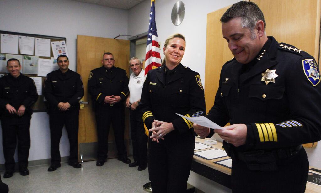 Police Chief Ken Savano, right, presented Lt.Tara Salizzoni with a new badge as Deputy Police Chief, a position that has not been held since 1963 on March 14, 2017.(CRISSY PASCUAL/ARGUS-COURIER STAFF)