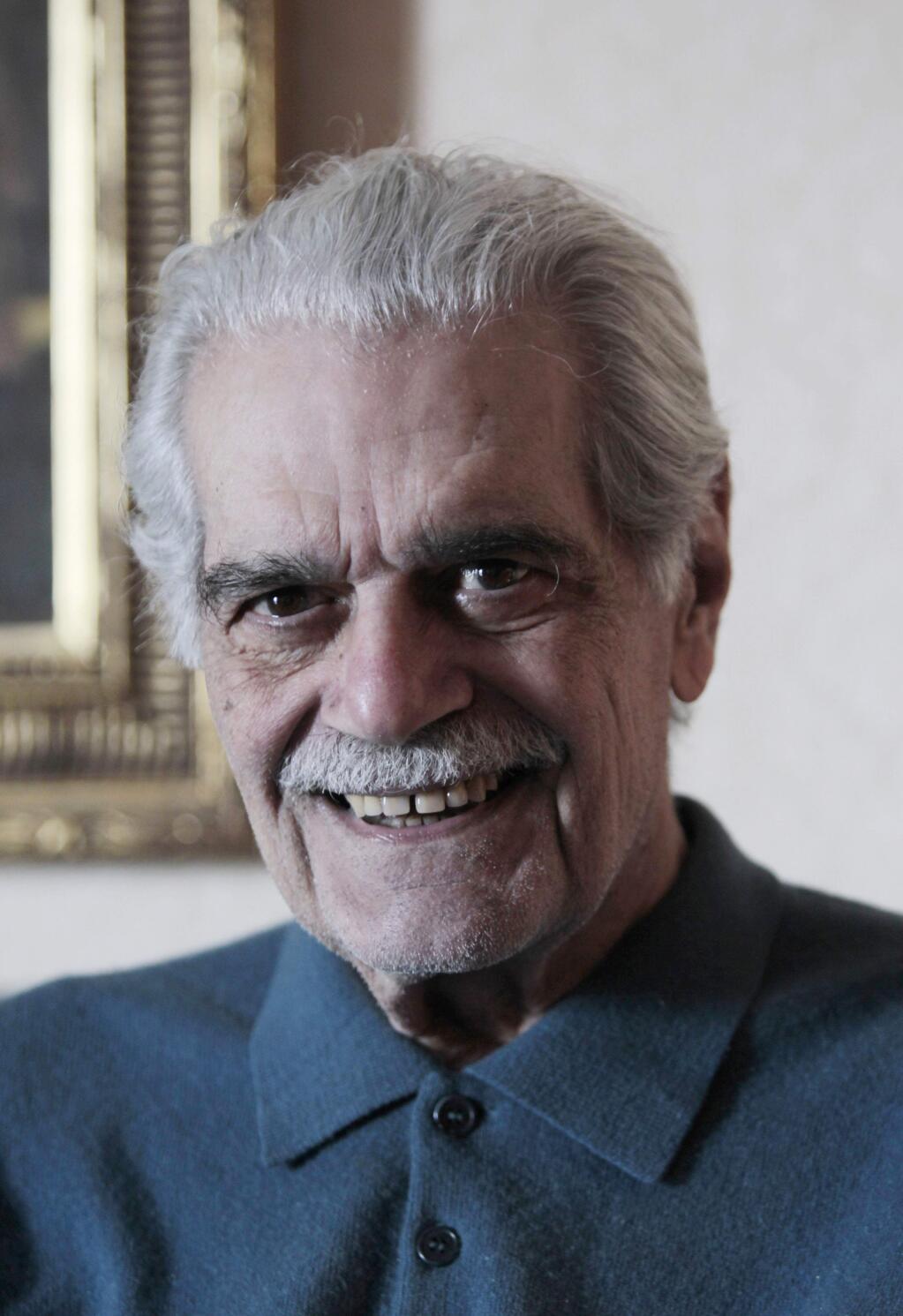 In this Monday, Jan. 31, 2011 photo, Egyptian actor Omar Sharif poses for a photograph at his home in Cairo, Sharif has died in a Cairo hospital of a heart attack, his agent said on Friday, July 10, 2015.(AP Photo/Lefteris Pitarakis)