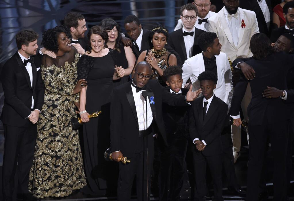Barry Jenkins, foreground center, and the cast accept the award for best picture for 'Moonlight' at the Oscars on Sunday, Feb. 26, 2017, at the Dolby Theatre in Los Angeles. (Photo by Chris Pizzello/Invision/AP)