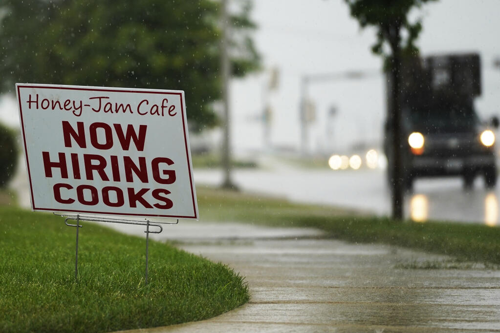 A hiring sign is shown in Downers Grove, Ill., Thursday, June 24, 2021. The number of Americans collecting unemployment benefits slid last week, another sign that the job market continues to recover rapidly from the coronavirus recession.Jobless claims dropped by 24,000 to 400,000 last week, the Labor Department reported Thursday, July 29, 2021. (AP Photo/Nam Y. Huh, File)