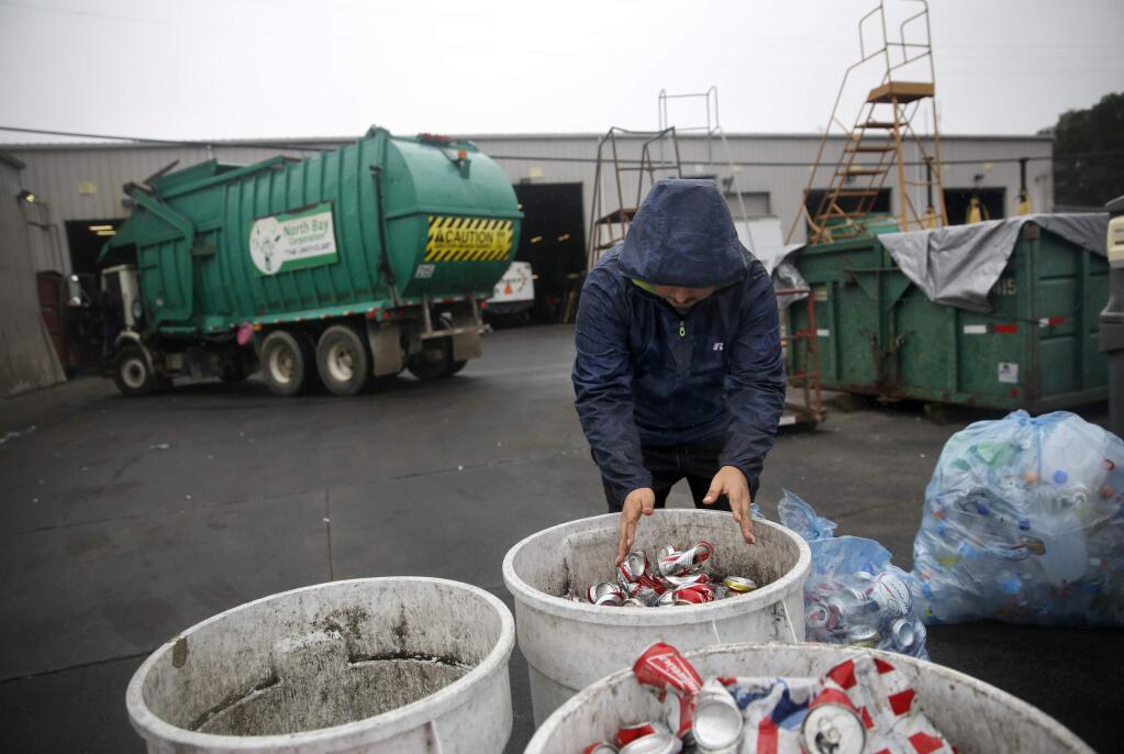 Julio Luna drops off bags of cans and bottles from a recent party at Redwood Empire Disposal on Monday, October 24, 2016 in Santa Rosa, California . (BETH SCHLANKER/ The Press Democrat)
