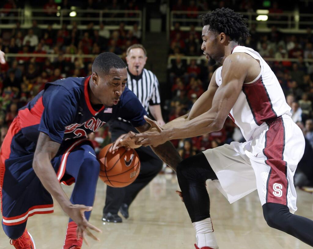Arizona's Rondae Hollis-Jefferson, left, strips the ball from Stanford's Chasson Randle during the second half of a game Thursday, Jan. 22, 2015, in Stanford. Arizona won 89-82. (AP Photo/Marcio Jose Sanchez)