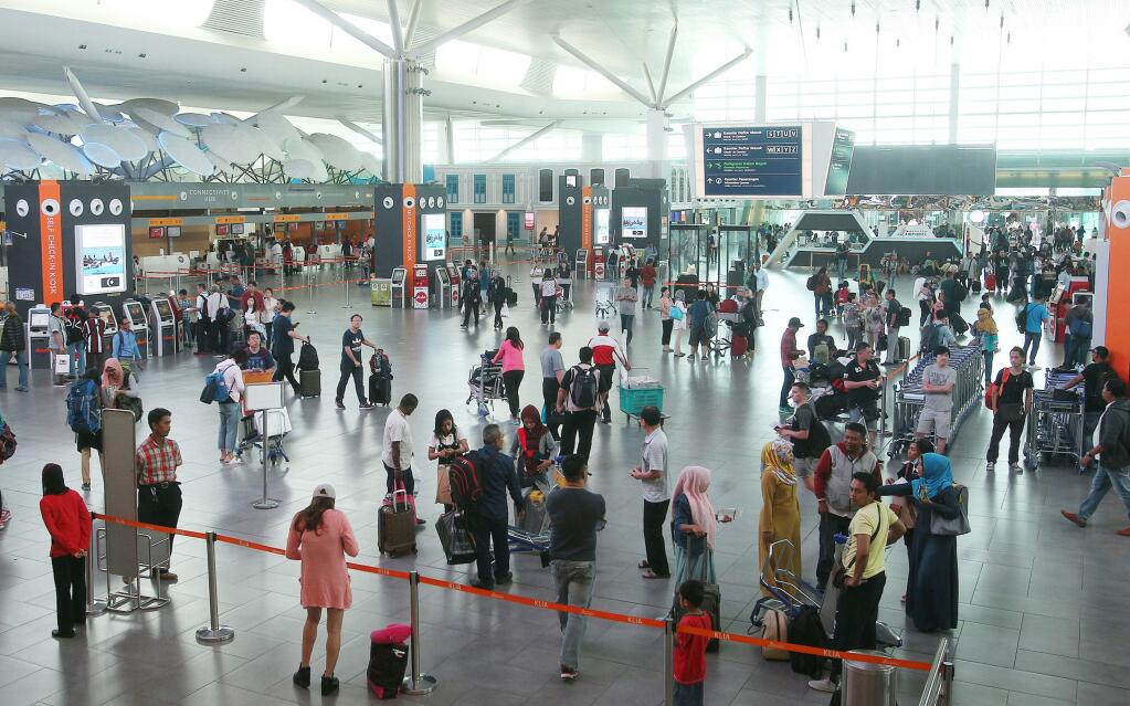 People move through the airport hall at the Kuala Lumpur International Airport in Sepang, Malaysia, Friday, Feb. 24, 2017. According to police Friday, forensics has stated that the banned chemical weapon VX nerve agent was used to kill Kim Jong Nam, the North Korean ruler's outcast half brother who was poisoned last week at the airport. The announcement raised serious questions about public safety in a building that authorities went 11 days without decontaminating. (AP Photo)