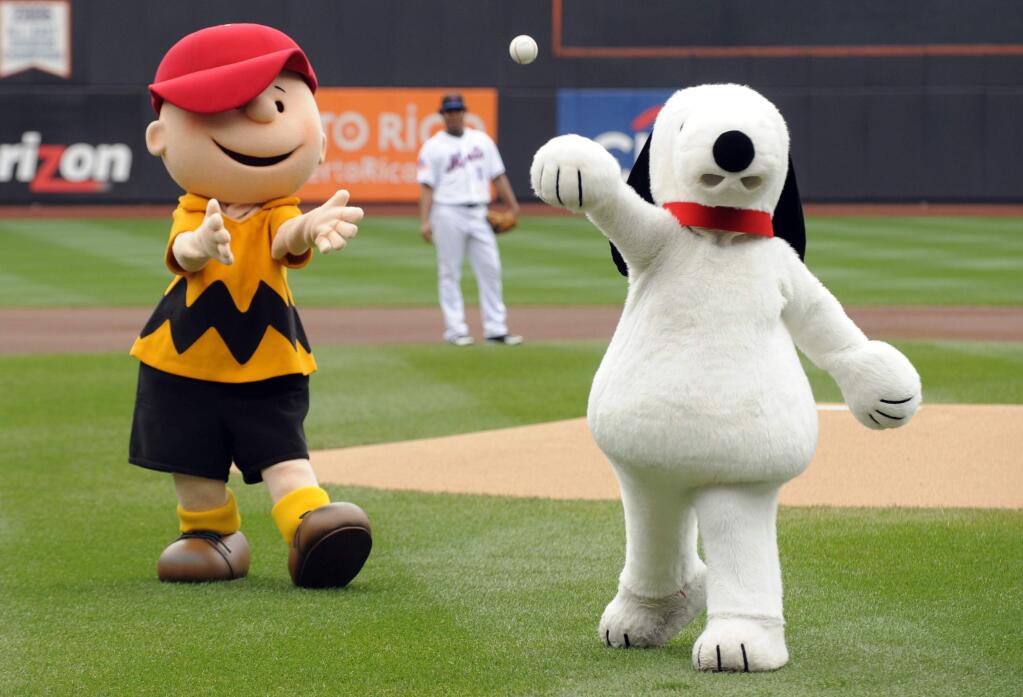 In this Oct. 3, 2009 file photo, Snoopy, right, throws out the ceremonial first pitch while Charlie Brown looks on prior to the New York Mets playing the Houston Astros in a baseball game at Citi Field in New York. Japanese electronics maker Sony Corp.'s music unit is buying a stake in Peanuts Holdings, the company behind Snoopy and Charlie Brown. Sony Music Entertainment said Monday, May 14, 2018, it signed a deal with DHX Media, based in Nova Scotia, Canada, to acquire 49 percent of the 80 percent stake DHX holds in Peanuts. (AP Photo/Henny Ray Abrams, File)
