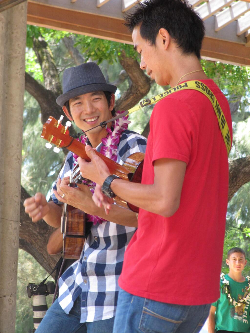 Jake Shimabukuro, left, performs with his brother Bruce Shimabukuro at the 41st Annual Ukulele Festival in Honolulu. (Audrey McAvoy/ Associated Press)