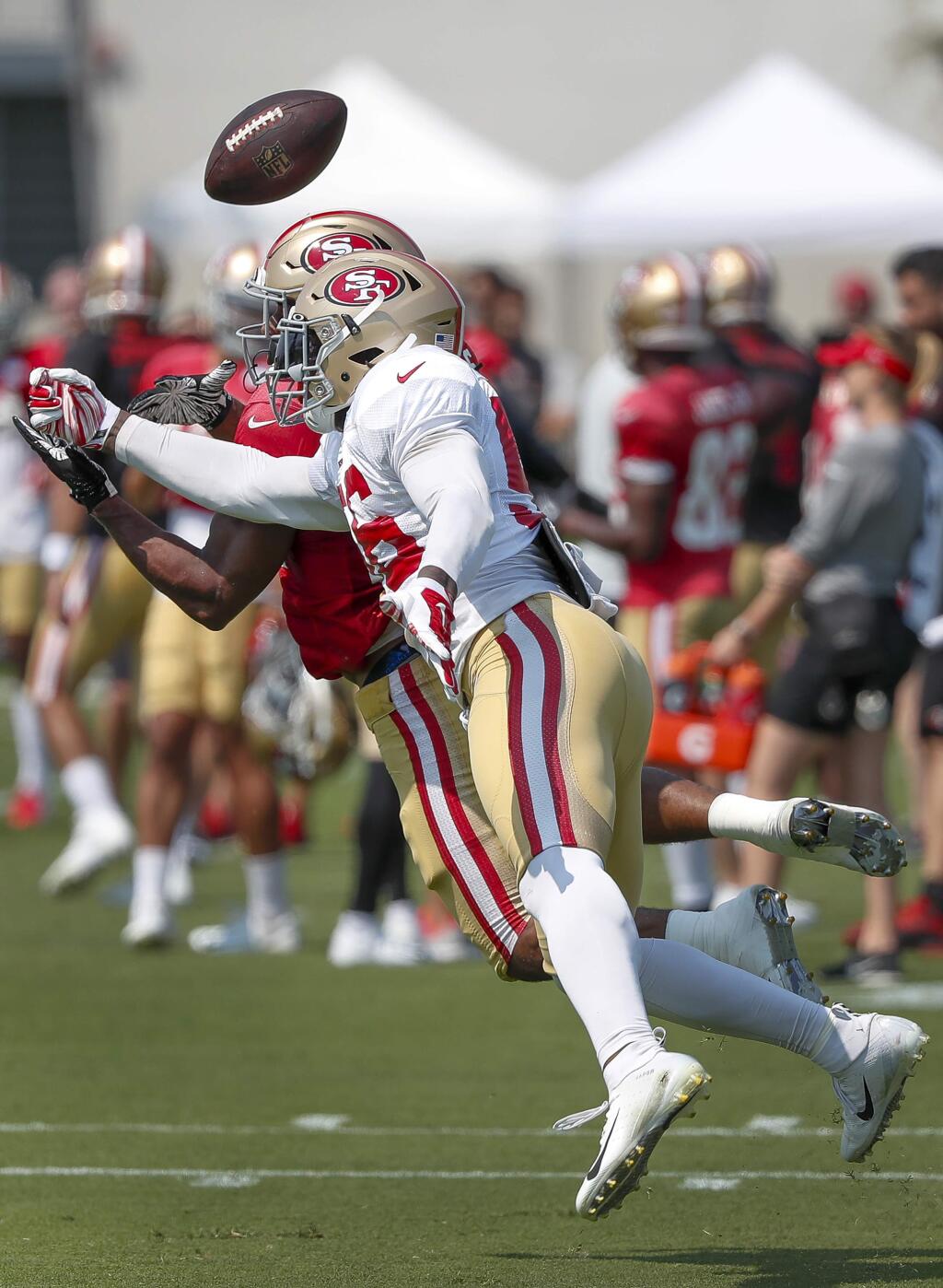 San Francisco 49ers linebacker Reuben Foster (56) breaks up a pass for running back Jeremy McNichols during NFL football practice at the team's headquarters Saturday, July 28, 2018, in Santa Clara, Calif. (AP Photo/Tony Avelar)