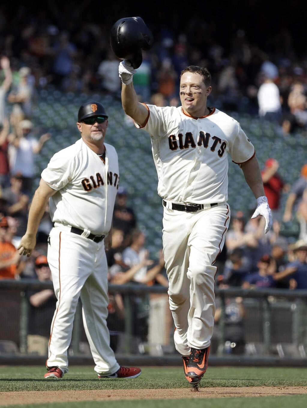 San Francisco Giants' Nick Hundley, right, celebrates after hitting a home run against the St. Louis Cardinals to win the baseball game in the tenth inning on Saturday, Sept. 2, 2017, in San Francisco. (AP Photo/Ben Margot)