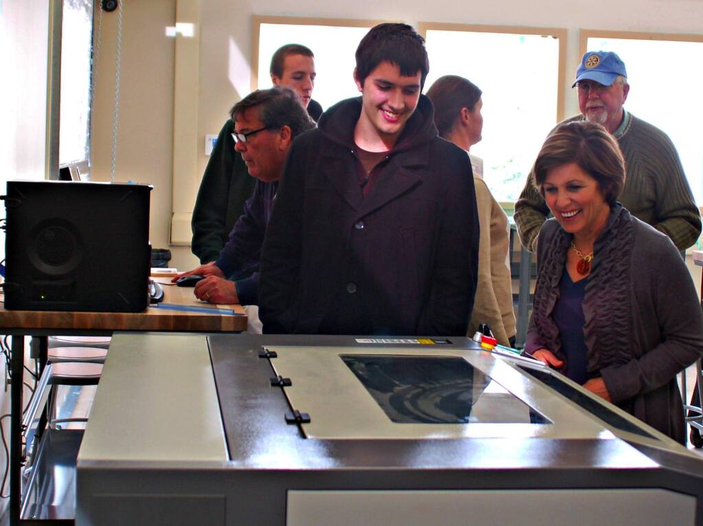Lorna Sheridan/Index-TribuneSVHS senior Stephen Orr showed off the laser cutter in the school's new Maker Space to Laura Zimmerman of the Sonoma Valley Education Foundation on a recent grand opening tour for donors.