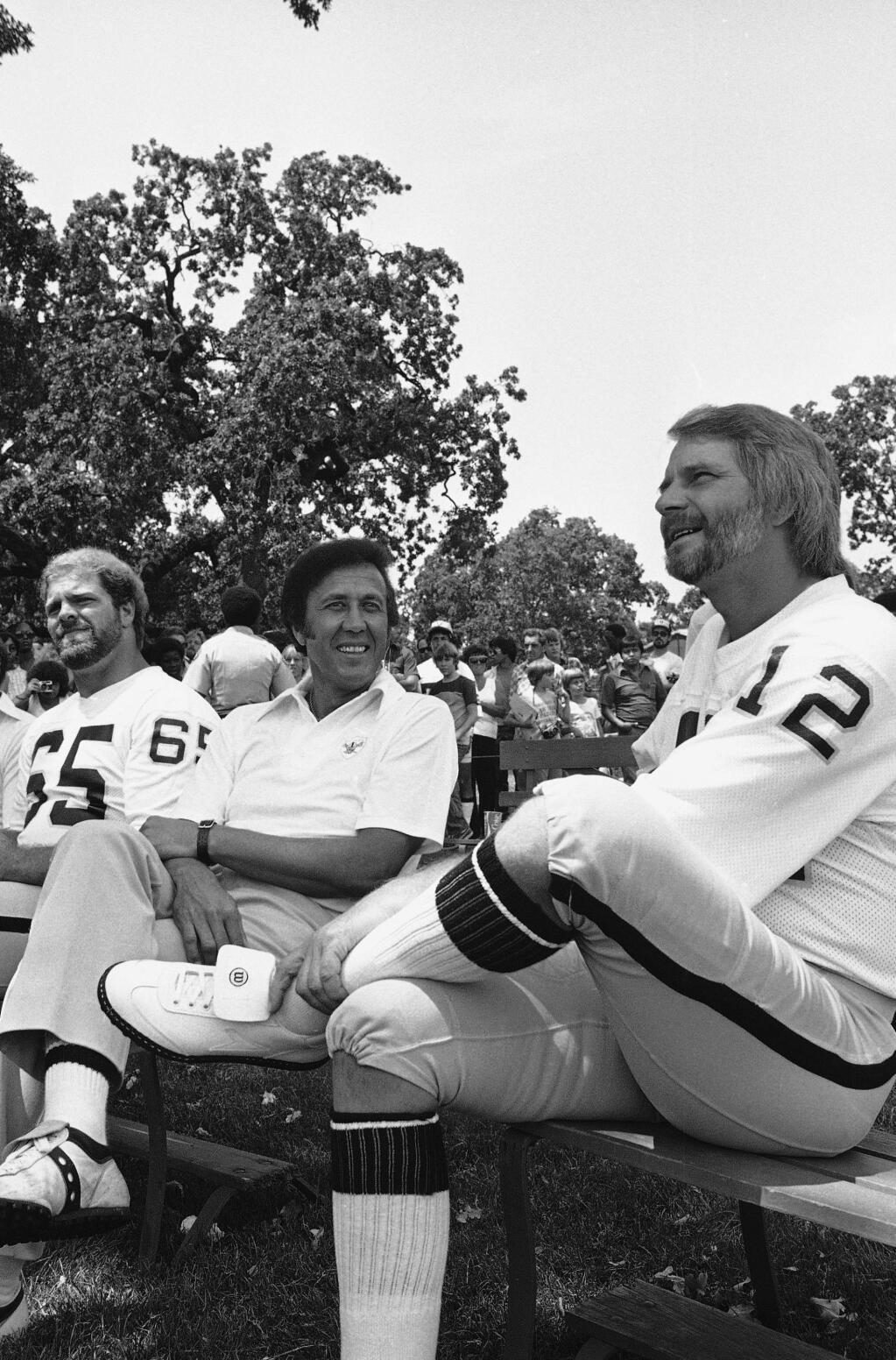 Oakland Raiders quarterback Ken Stabler chats with head coach Tom Flores during Stablers second day of training camp in Santa Rosa, California Saturday, July 22, 1979. All 98 of the players were introduced for the first time to a crowd of about 5,000 during Family Day. The veteran quarterback said he still wants to be traded to another team. (AP Photo/Rich Pedroncelli)