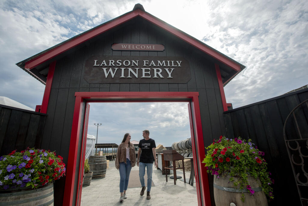 General Manager Erica Larson and Tasting Room Manager Hayden Puryear walk through the new entrance to the Larson Family Winery on Millerick Road on Monday, Aug. 1, 2022. (Robbi Pengelly/Index-Tribune)