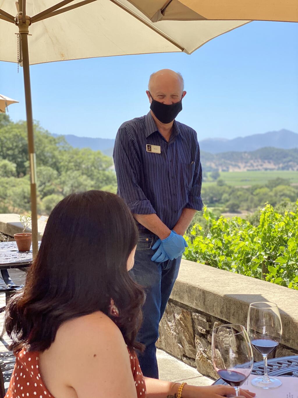 A Silverado Vineyards staff member serves a visitor July 2, 2020, on one of the outdoor terraces overlooking Napa Valley. (courtesy photo)