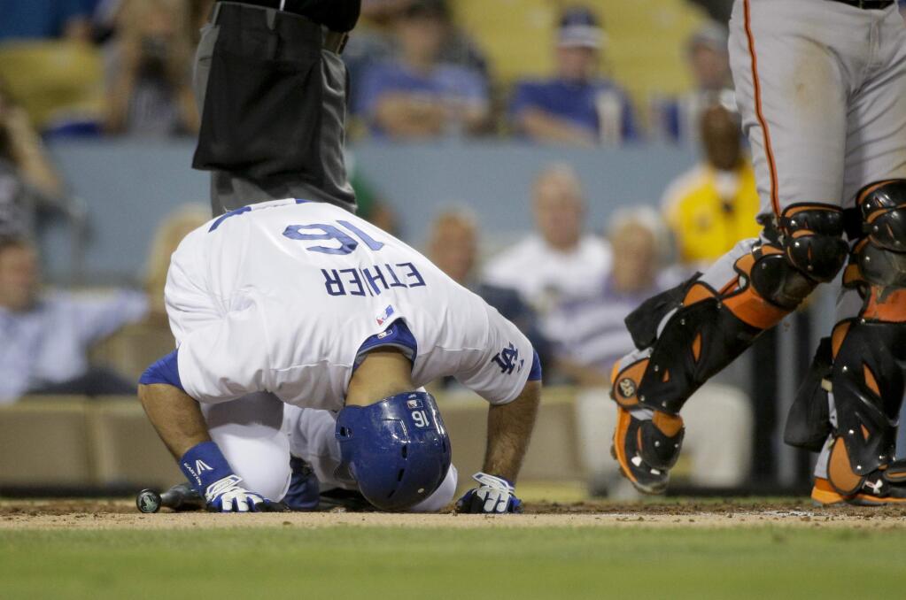 Los Angeles Dodgers' Andre Ethier kneels in pain after swinging at a pitch during the second inning of a baseball game against the San Francisco Giants, Wednesday, Sept. 2, 2015, in Los Angeles. (AP Photo/Jae C. Hong)