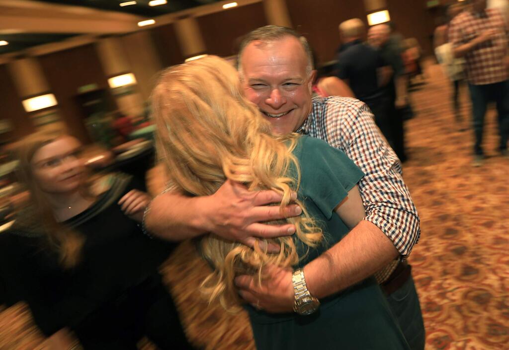 Mark Essick, running for Sonoma County sheriff, embraces his wife Andi, at his campaign party at the Flamingo Hotel, Tuesday, June 5, 2018 in Santa Rosa. Essick was holding a comfortable lead over rivals John Mutz and Ernesto Olivares. (Kent Porter / The Press Democrat) 2018