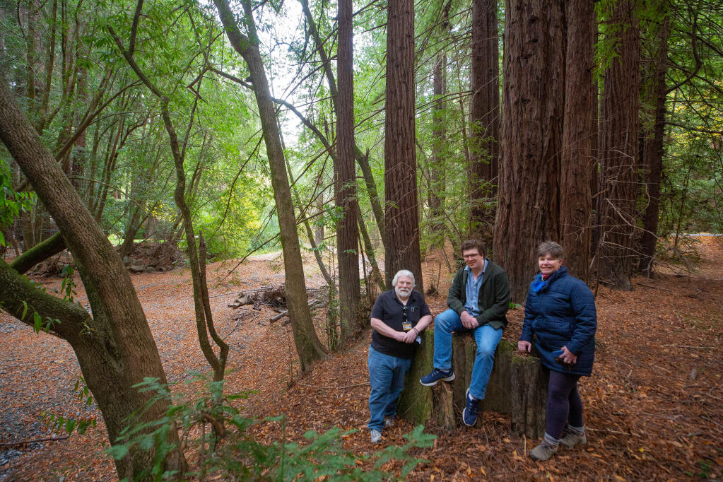 Former owners Michael Torr, left, his son, Kyle, and sister Michele McDonell pose for a portrait beside Dutch Bill Creek at the 515-acre property that will become Sonoma County's newest park in Monte Rio on Wednesday, Nov. 11, 2020. (Alvin A.H. Jornada / The Press Democrat)