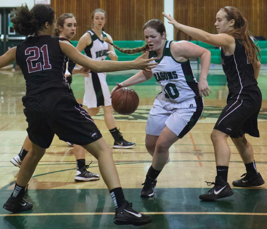 Robbi Pengelly/Index-TribuneSonoma's Bella Bollman drives the lane through two Greyhound defenders as teammate Alexa Hall (back, No. 14) follows the play during the Lady Dragons' SCL victory over Healdsburg last Thursday night in Pfeiffer Gym.