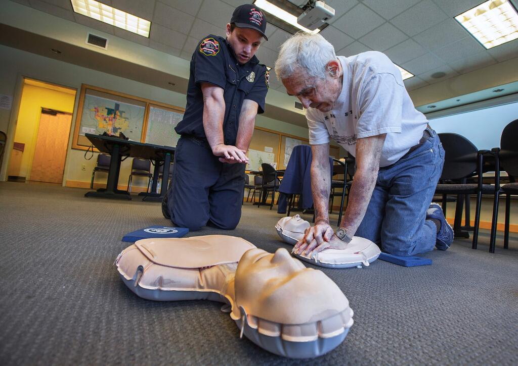 Robbi Pengelly/Index-TribuneSonoma Valley paramedic engineer Ryan McCracken shows Bob Alwitt the most efficient way to administer CPR, a lifesaving technique useful in many emergencies. As part of National Emergency Medical Services Week, the Sonoma Valley Fire and Rescue Authority hosted a free 'hands only' CPR class last Tuesday that was open to anyone who wanted to attend.